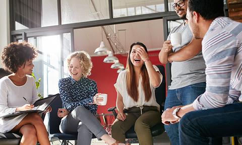 inclusive group of team members laughing in a meeting